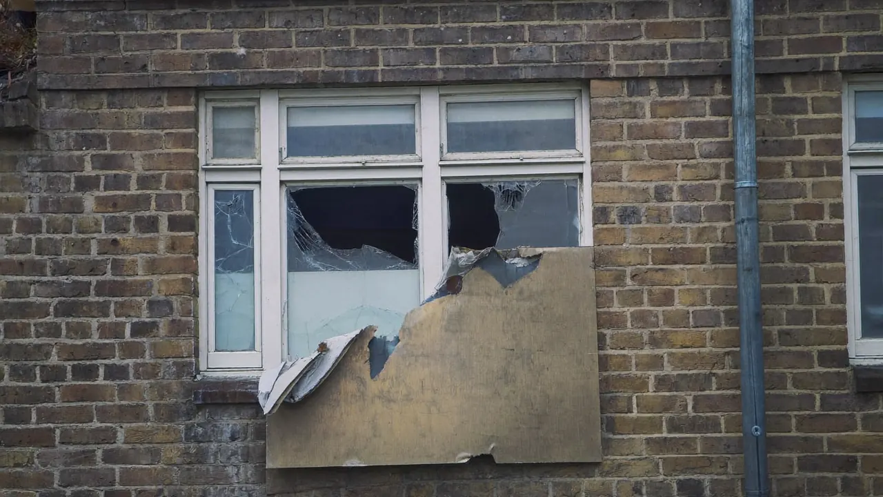 Boarded-up window on a UK home after storm damage awaiting replacement